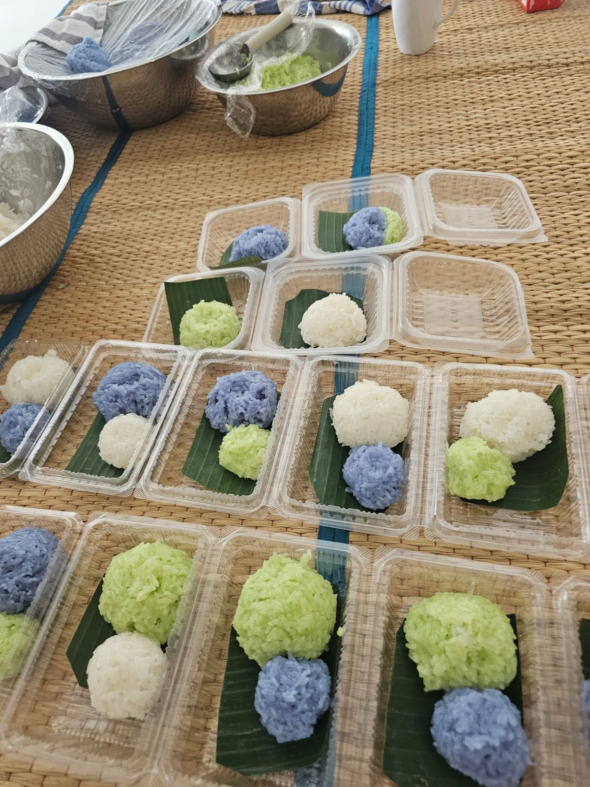 A close-up of authentic Thai mango sticky rice, neatly packed in a box.